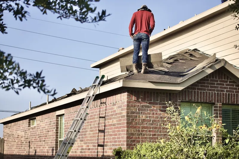 Professional roofer working on a residential roof in Somersville